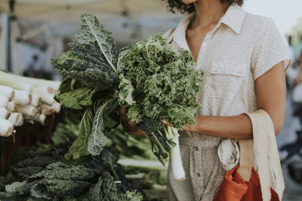 Woman shopping for fresh vegetables at the Vancouver Farmers Market